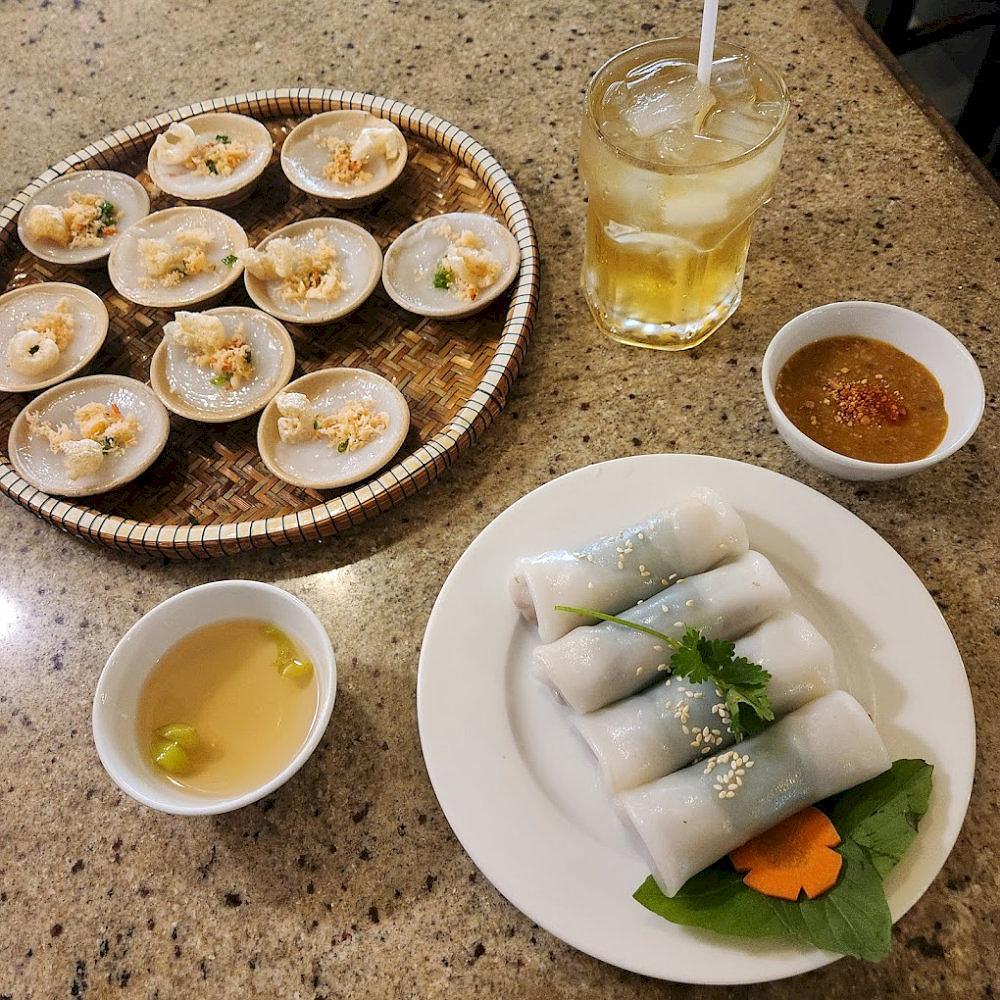 Each delicate cup of banh beo is topped with savory dried shrimp and crispy shallots, offering the essence of central Vietnamese cuisine 